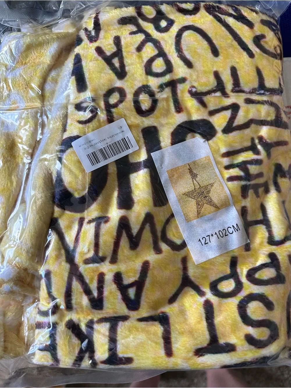 Yellow Star Typography fuzzy blanket new in package.  Pic shows blanket and size